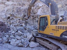 Excavator working a rock face