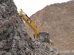 Excavator on the quarry slope